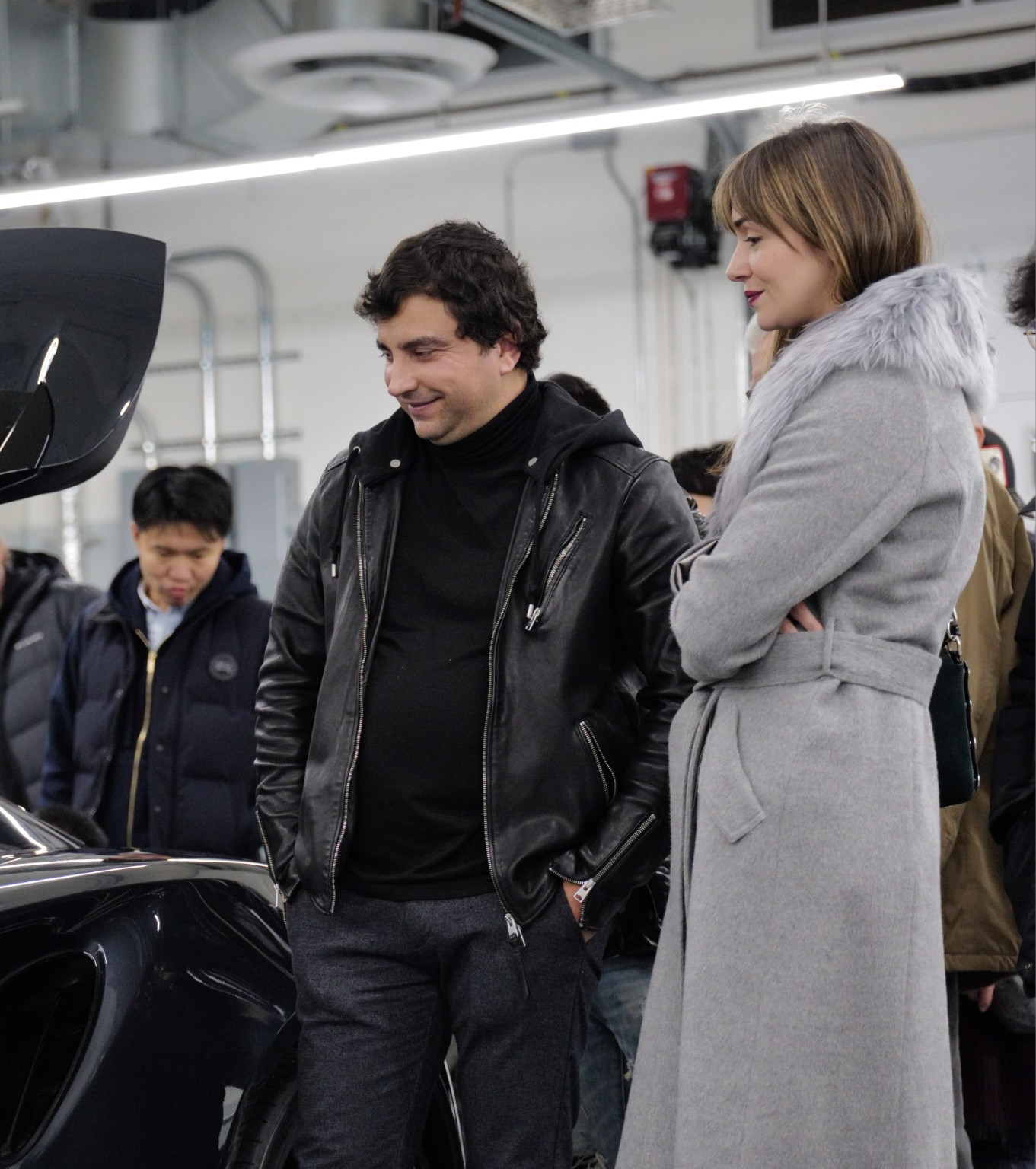 Guests looking at a car in a bright showroom